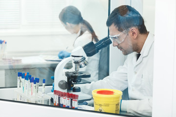 Experienced researcher is doing examination in lab