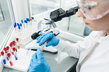 Professional young scientist is analyzing sample