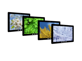 Fototapeta premium four tablet computers with images of seasons