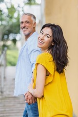 Portrait of happy woman holding mans hand