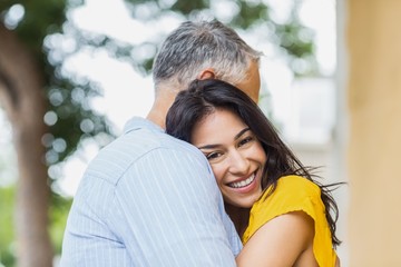 Fototapeta premium Portrait of woman hugging man