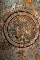 Fototapeta na wymiar Rusty weathered antique cast iron wood stove burner cover plates