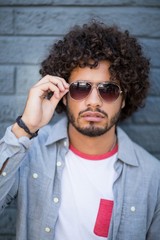 Obraz premium Portrait of young man in sunglasses