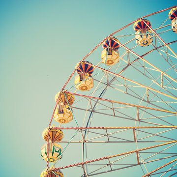 Vintage ferris wheel over blue sky