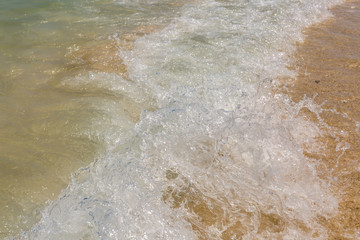 Fototapeta na wymiar wave of the sea on sand beach