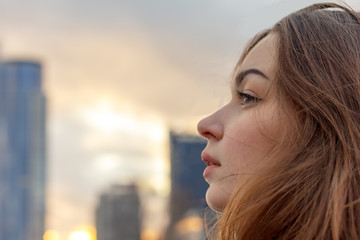 young attractive girl on the background of buildings