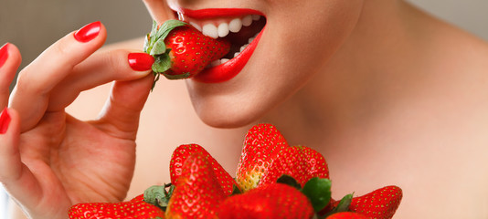 Woman eating strawberry