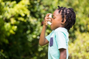 Boy using an asthma inhaler - 110124158