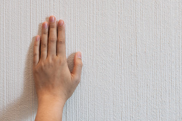 Hand on scratched concrete.
