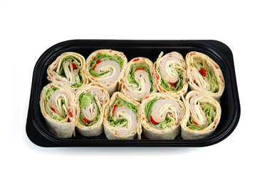 tortilla deli wrap rolls with ham vegetable in container isolated on white background