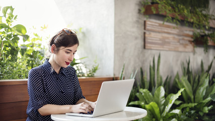 Woman Using Laptop Working Browsing Concept
