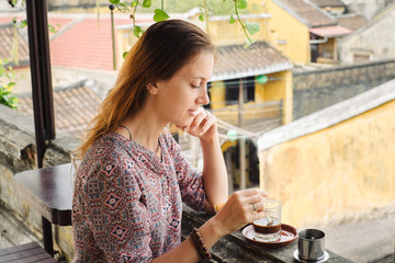 Woman tastes vietnamese coffee