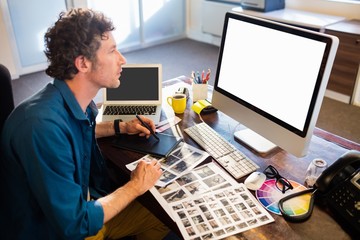 Fototapeta na wymiar Photographer working on his computer 