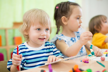 kids making arts and crafts in day care centre together