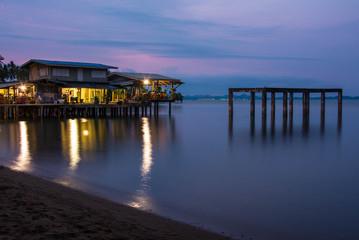 Fototapeta na wymiar house on the beach with sunset over the sea on koh chang island, Thailand
