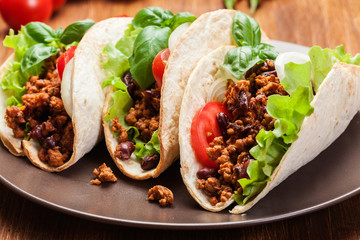 Mexican tacos with minced meat, beans and spices