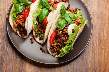 Mexican tacos with minced meat, beans and spices