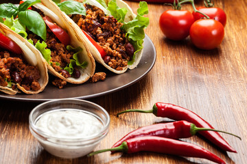 Mexican tacos with minced meat, beans and spices