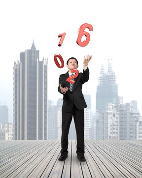Businessman catching throwing 2016 red words
