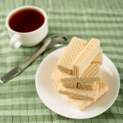 Wafer biscuits served with tea.