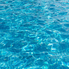 Background of rippled pattern of clean water in a blue swimming
