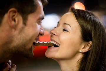 Couple eating chocolate on date