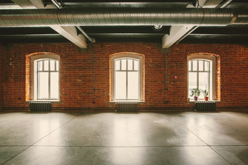 Loft studio Interior in old house. Big windows, brick red wall - Powered by Adobe