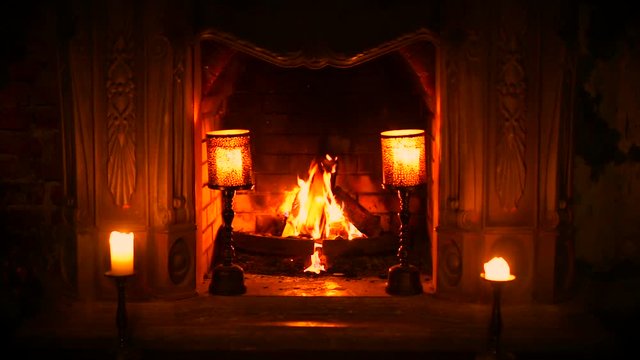 The old Gothic fireplace is a fire. Burning candles. Condition of peace and relaxation