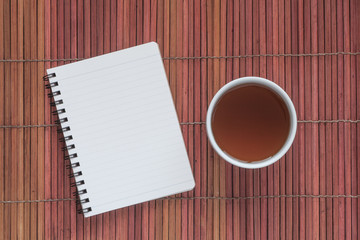 Blank note book with a cup of chinese hot tea
