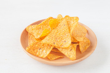 Tortilla chip , a snack food made from corn tortillas