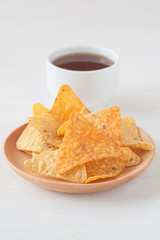 Tortilla chip , a snack food made from corn tortillas