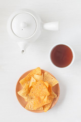 Tortilla chip , a snack food made from corn tortillas