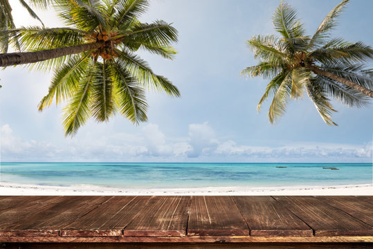 Old wood table with blurred sea and coconut tree background - Empty ready for your product display montage. Concept of beach in summer