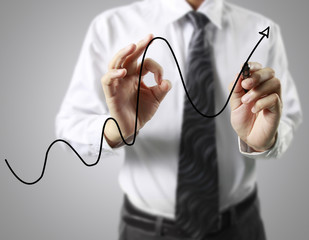 Businessman drawing graphics  growing graph