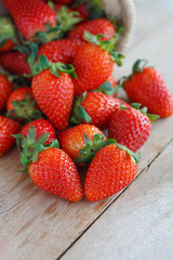 strawberries in small sack on wooden table background