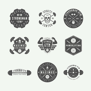 Set of gym logos, labels and slogans in vintage style.