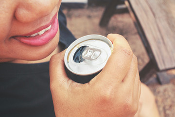Fototapeta premium Woman drinking cola can