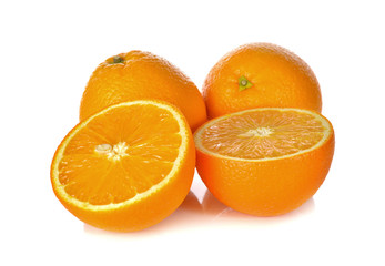 whole and cut ripe orange on white background