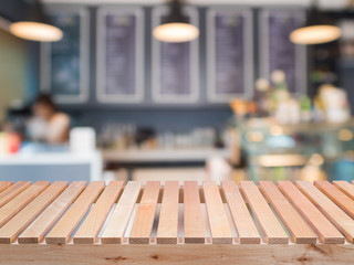 wooden counter top with bakery shop blurred background