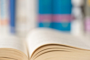 Detail view of open book in library. Shallow depth of field. Horizontal shot.