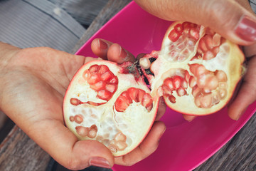 Pomegranate fruit with hands