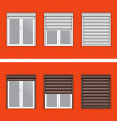 Windows with rolling shutters on red brick wall