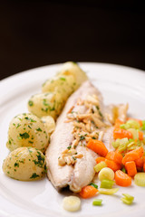 Closeup of fine dine dinner Plate with Grilled White Fish and Vegetables
