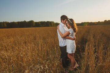 happy young couple in love romance fun wheat field summer