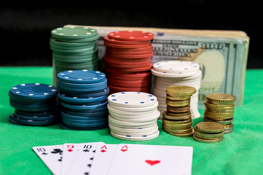 four aces with dollars and chips on green cloth