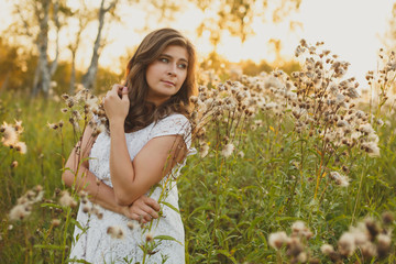 Naklejka na ściany i meble beautiful brown-haired girl in the Ukrainian high grass
