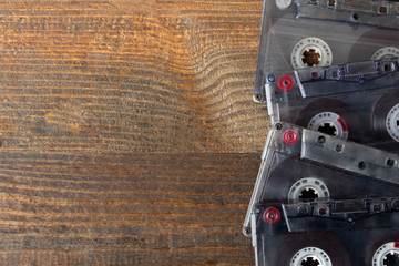 grey audio tapes on brown wooden background