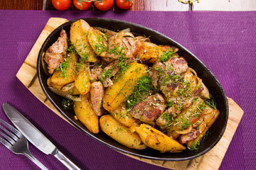 meat with potatoes in pen