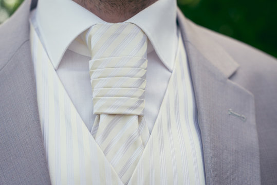 Detail view of groom's wedding suit with tie.