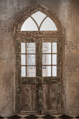 Ancient wooden door in stone wall